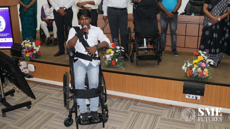 scientist at IIT Madras showing electric standing wheelchair